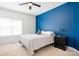 Bedroom with blue accent wall, ceiling fan and neutral colored carpeting at 7525 Blackgum Falls Ct, Huntersville, NC 28078