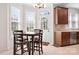 Bright breakfast nook with square table set, natural light, and view of the backyard at 7525 Blackgum Falls Ct, Huntersville, NC 28078