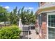 Inviting backyard deck featuring a grill and outdoor furniture with lush greenery at 7525 Blackgum Falls Ct, Huntersville, NC 28078