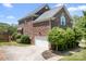 Charming brick home featuring an attached garage, a well-manicured lawn, and a lovely driveway at 7525 Blackgum Falls Ct, Huntersville, NC 28078