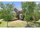 Beautiful home with a manicured lawn, mature trees, brick exterior, and inviting front entrance on a sunny day at 7525 Blackgum Falls Ct, Huntersville, NC 28078