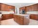 Spacious kitchen featuring custom cabinetry, stainless steel appliances, a center island and tile flooring at 7525 Blackgum Falls Ct, Huntersville, NC 28078