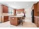 Well-lit kitchen with a center island, stainless steel appliances, ample cabinetry, and tile flooring at 7525 Blackgum Falls Ct, Huntersville, NC 28078