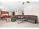 Open-concept living room with tile flooring, large sectional, and direct access to kitchen area at 7525 Blackgum Falls Ct, Huntersville, NC 28078