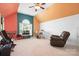 A colorful living room with musical instruments, a chair, and a window at 7525 Blackgum Falls Ct, Huntersville, NC 28078
