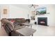 Living room featuring a fireplace, ceiling fan and a television above the mantle at 7525 Blackgum Falls Ct, Huntersville, NC 28078