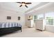 A large main bedroom with a ceiling fan, wall art, and two dressers with a TV on top at 7525 Blackgum Falls Ct, Huntersville, NC 28078