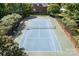 Outdoor tennis court surrounded by shade trees and benches at 7525 Blackgum Falls Ct, Huntersville, NC 28078