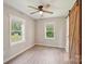 Bedroom with new flooring, two windows, and a sliding barn door at 814 Marve St, Gastonia, NC 28052