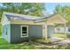 View of the front of the blue home, highlighting the window and covered porch at 814 Marve St, Gastonia, NC 28052