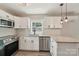 Modern kitchen boasts stainless appliances, granite counters, white cabinets, and new fixtures at 814 Marve St, Gastonia, NC 28052