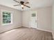 Open living area with wood floors, a ceiling fan, and a bright window showcasing the exterior at 814 Marve St, Gastonia, NC 28052