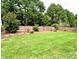 Well-maintained backyard with a large grassy area, complemented by a wooden privacy fence at 8218 Lynnewood Glen Dr, Charlotte, NC 28269
