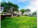 Expansive backyard featuring a screened porch, lush lawn, mature trees, and a trampoline, perfect for outdoor activities at 8218 Lynnewood Glen Dr, Charlotte, NC 28269