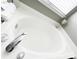 A clean white bathtub has chrome fixtures, and is located beneath a window with blinds at 8218 Lynnewood Glen Dr, Charlotte, NC 28269