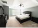 Spacious bedroom featuring a tray ceiling, ceiling fan, and large window for natural light at 8218 Lynnewood Glen Dr, Charlotte, NC 28269