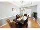 Elegant dining room with hardwood floors, gray paint, and decorative chandelier at 8218 Lynnewood Glen Dr, Charlotte, NC 28269