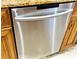 Close-up of a stainless steel dishwasher in a kitchen with wooden cabinets at 8218 Lynnewood Glen Dr, Charlotte, NC 28269