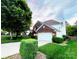 Beautiful two-story brick home with green lawn, mature trees, and an attached two-car garage at 8218 Lynnewood Glen Dr, Charlotte, NC 28269