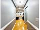 Hallway with hardwood floors, leading to the living area with fireplace and comfortable seating at 8218 Lynnewood Glen Dr, Charlotte, NC 28269