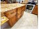Kitchen featuring a granite-topped island, tile floors, and stainless steel appliances at 8218 Lynnewood Glen Dr, Charlotte, NC 28269
