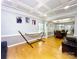 Living room with hardwood floors, tray ceiling, and open layout to dining area; a cozy hammock is situated in the corner at 8218 Lynnewood Glen Dr, Charlotte, NC 28269