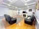 Cozy living room with a fireplace, hardwood floors, and coffered ceiling provides an inviting atmosphere at 8218 Lynnewood Glen Dr, Charlotte, NC 28269