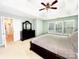This main bedroom boasts a large window and light, neutral colored walls and carpet at 8218 Lynnewood Glen Dr, Charlotte, NC 28269
