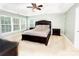 Spacious main bedroom with a tray ceiling, neutral walls, carpeted floor, and a large window at 8218 Lynnewood Glen Dr, Charlotte, NC 28269