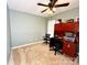 This office features carpet, a ceiling fan, and a large desk with a black office chair at 8218 Lynnewood Glen Dr, Charlotte, NC 28269
