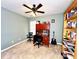 A carpeted office features a ceiling fan, a desk with shelves, and a built-in bookcase at 8218 Lynnewood Glen Dr, Charlotte, NC 28269