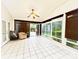 Inviting sunroom boasts tile flooring, natural light from large windows, and a cozy seating area at 8218 Lynnewood Glen Dr, Charlotte, NC 28269