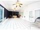 Bright sunroom featuring tiled flooring, two ceiling fans, multiple windows, and access to the backyard at 8218 Lynnewood Glen Dr, Charlotte, NC 28269