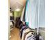This large walk-in closet has organized shelving and hanging racks for your wardrobe needs at 8218 Lynnewood Glen Dr, Charlotte, NC 28269