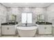 Luxurious bathroom featuring a standalone tub, double vanity, and marble backsplash at 8707 Fairview Rd, Charlotte, NC 28226