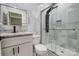 Luxurious bathroom with a sleek glass shower, mosaic tile, and granite vanity with modern fixtures at 8707 Fairview Rd, Charlotte, NC 28226