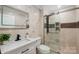 Bathroom with updated tile, glass shower, and modern vanity at 8707 Fairview Rd, Charlotte, NC 28226