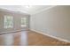 This room has hardwood floors, two windows, and white trim that adds an elegant touch at 8707 Fairview Rd, Charlotte, NC 28226