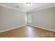 Bright, airy bedroom with hardwood floors and a window creating a light, inviting space at 8707 Fairview Rd, Charlotte, NC 28226