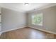 Bright room featuring hardwood floors and a window creating a light, inviting space at 8707 Fairview Rd, Charlotte, NC 28226