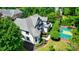 Aerial view of the home showing the gray roof and a basketball court on the meticulously landscaped property at 8707 Fairview Rd, Charlotte, NC 28226