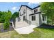 Rear exterior showcasing the stone patio and stairway leading to the manicured backyard of the home at 8707 Fairview Rd, Charlotte, NC 28226