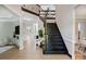 Bright foyer featuring hardwood floors, beautiful staircase with iron spindles and an open floor plan at 8707 Fairview Rd, Charlotte, NC 28226