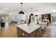 Open-concept kitchen with island seating overlooking a living area with vaulted ceilings and plenty of natural light at 8707 Fairview Rd, Charlotte, NC 28226