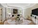 Bright living room with a decorative rug, comfortable seating, and plenty of natural light at 8707 Fairview Rd, Charlotte, NC 28226