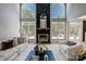 Bright living room with high ceilings, fireplace, large windows and neutral furniture at 8707 Fairview Rd, Charlotte, NC 28226