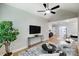 Open-concept living room with hardwood floors, modern decor, and a ceiling fan at 8707 Fairview Rd, Charlotte, NC 28226