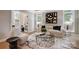Comfortable and stylish living room featuring modern decor, a glass coffee table, and large windows at 8707 Fairview Rd, Charlotte, NC 28226