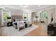 Large main bedroom with a seating area and a decorative headboard at 8707 Fairview Rd, Charlotte, NC 28226