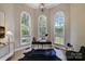 Bright home office with three large windows, modern desk, and contemporary chandelier at 8707 Fairview Rd, Charlotte, NC 28226